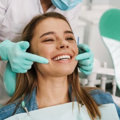 dental_image Smiling patient receiving emergency dental care with 24-hour booking availability for urgent treatment.